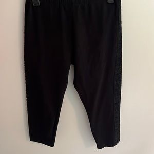 Black Capri tights with lace on sides of both legs